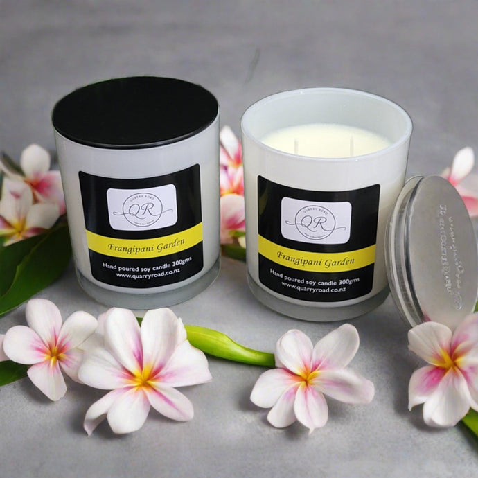 Quarry Road Candle, Frangipani Garden Candle sitting on quarried rocks , delightful fragrance in a jar with two cotton wicks.